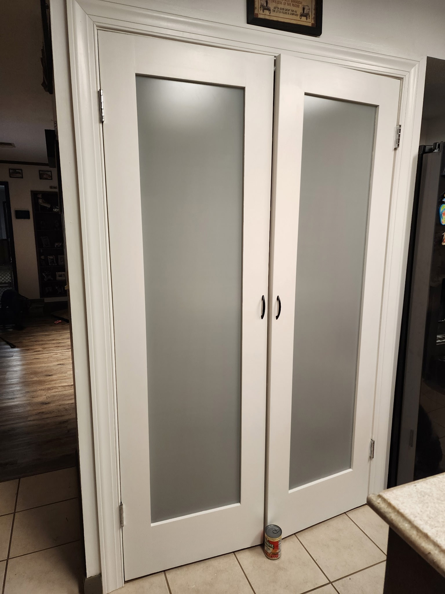 White double interior doors with frosted glass panels, newly installed.