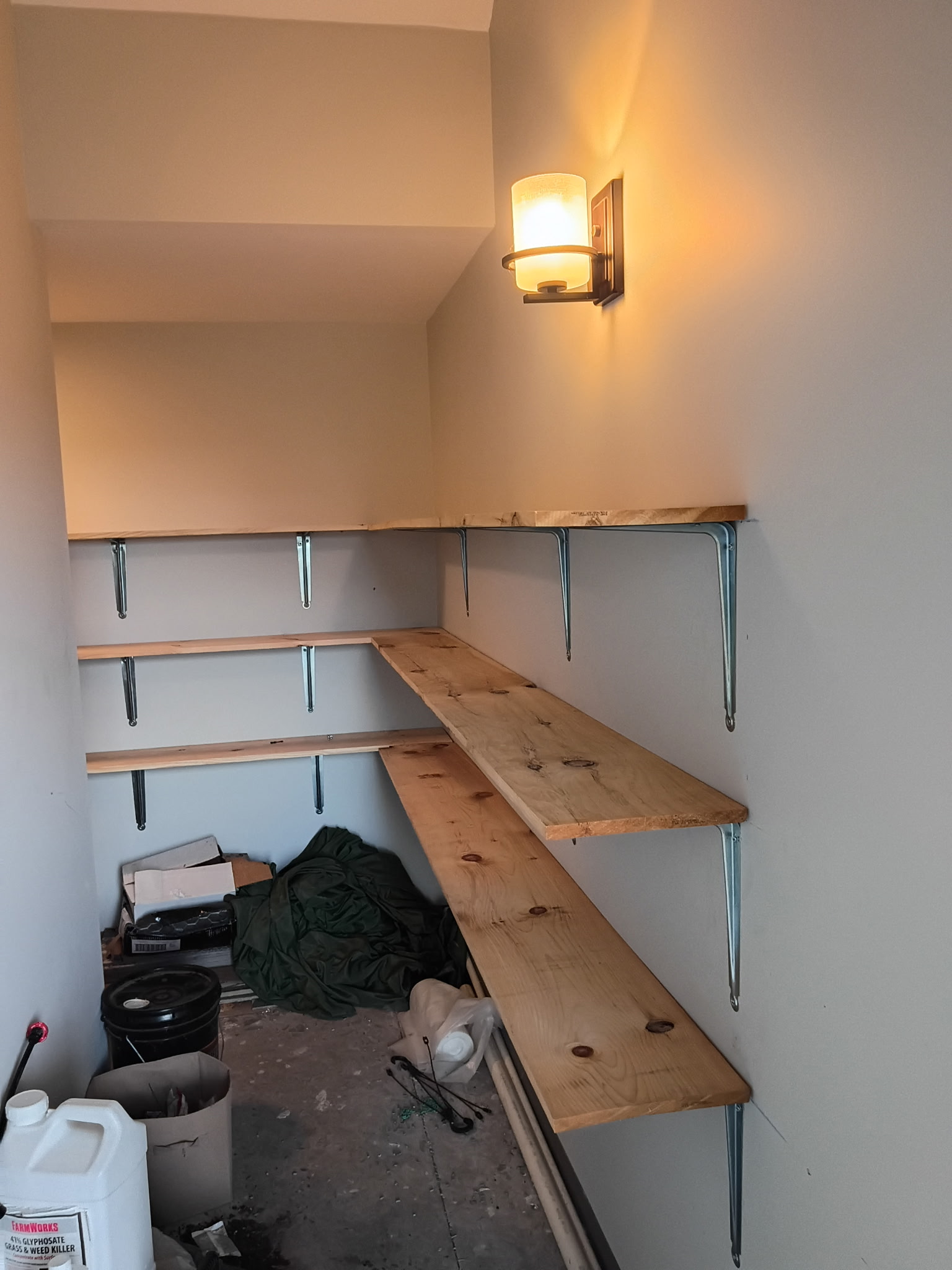 Pine corner pantry shelves with metal brackets, custom-cut to fit.